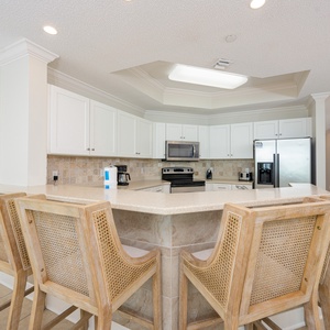 Sip your morning coffee at the breakfast bar and get ready for a beach day in this stylish space