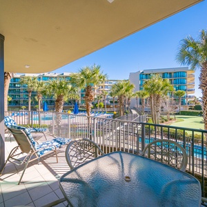 Breathe in the fresh air while lounging on the balcony, soaking in views of the lush palms and sparkling pool