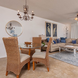 Unwind in the stylish living area featuring a plush sofa, elegant dining set, and captivating views through large windows