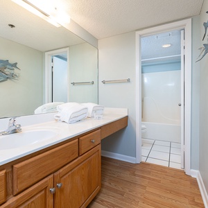 Experience relaxation in the master bathroom, where plush towels invite you to unwind after a day at the beach