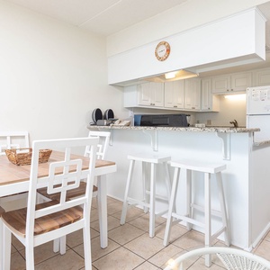 This inviting kitchen features a breakfast bar, modern appliances, and a cozy dining area for memorable meals together