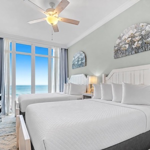 Wake to a breathtaking sunrise in this queen guest suite with two cozy beds and expansive views from the windows