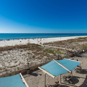 Take in the expansive views of the beach and pool area from your beachfront balcony