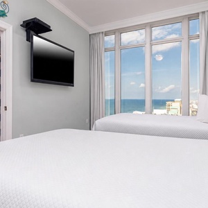 Unwind in this queen guest suite with stunning views and your favorite shows