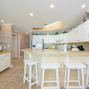 Sip your morning coffee at the breakfast bar and get ready for a beach day in this stylish space