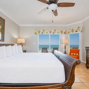 King bed in the master suite invites you to unwind while watching a sunset glow beyond your balcony doors