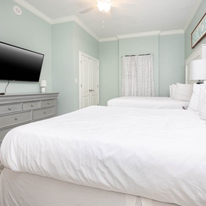 Retreat to the guest bedroom, where two cozy queen beds and a large TV create the perfect space to unwind after your day