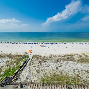 Enjoy the serene views of the calm waters and beach from your spacious balcony area, perfect for relaxation