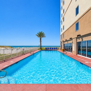Float in the outdoor pool with stunning views just steps away from the beach and your vacation rental a