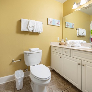 Refresh after a day at the beach in this guest bathroom, featuring plush towels and a spacious vanity