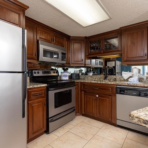 Cook and gather in this inviting kitchen, featuring granite countertops and stainless appliances
