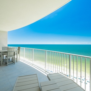 Relax on the balcony while enjoying breathtaking views of the tranquil waters and clear blue skies