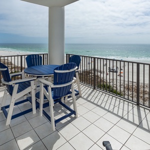 Gather around the charming table on your balcony, savoring the coastal views while making unforgettable family memories