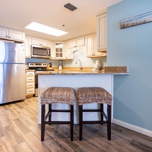 Enjoy preparing meals in this inviting kitchen, featuring stainless appliances and a breakfast bar