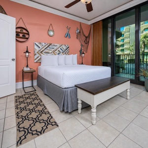 Charming sleeping area by the living room where the queen bed invites tranquility and sliding doors lead to the balcony