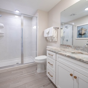 Refresh in this guest bathroom featuring a spacious vanity, elegant decor, and a walk-in shower