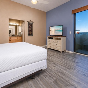 Enjoy a movie on the TV, and let natural light fill the room from the master suite patio