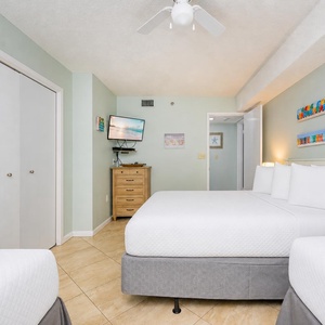 Drift into relaxation in this guest suite, with three beds and calming decor ready for restful beach nights