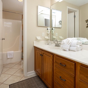 Refresh in this master bathroom featuring a spacious vanity, ample storage, and a relaxing tub-shower combo