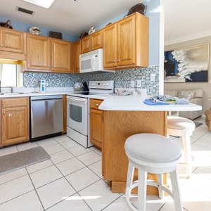 Kitchen featuring wooden cabinetry, a mosaic tile backsplash, and a breakfast bar with seating
