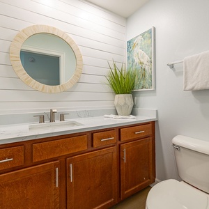 Refresh in the additional half bath, where elegant details invite you to unwind after a day by the coast