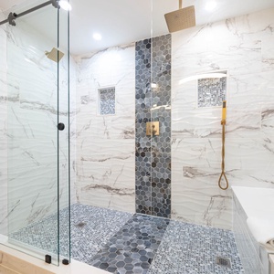 Indulge in this refreshing master bath shower, enjoying the elegant surroundings and invigorating rainfall showerhead