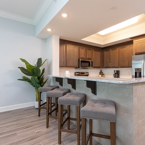 Savor your morning coffee at the breakfast bar with casual conversation in this inviting kitchen space