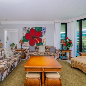 Unwind in the inviting living area with a queen sofa sleeper, surrounded by vibrant decor and comfortable seating