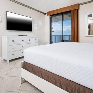 Relax in the inviting master bedroom, featuring a king bed and stylish decor, with beachfront access that enhances your stay