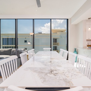 Dine in style at the elegant table, surrounded by beachfront views, while enjoying this stylish living space