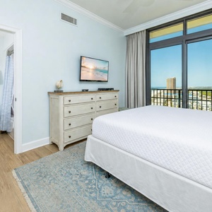 Gaze out at breathtaking views from your king bed, letting the coastal vibe wash over you in this guest bedroom