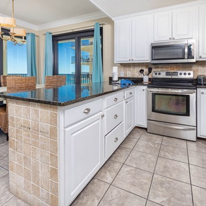 The bright kitchen features a breakfast bar with woven seating, sleek countertops, and a breakfast bar with glass shelves