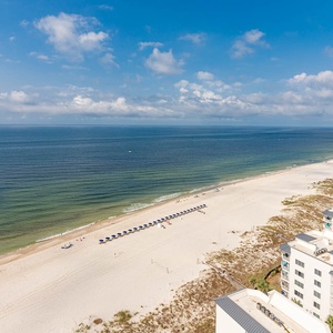 Admire the gulf stretching to the horizon above the wide beach area and stunning coastline