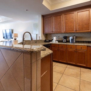 The kitchen features wood cabinets, stainless appliances, a Keurig and coffee maker, perfect for morning brews