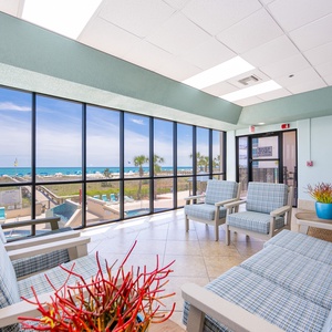 Relax in this inviting lounge with beach views, comfortable seating, and a cozy atmosphere perfect for unwinding
