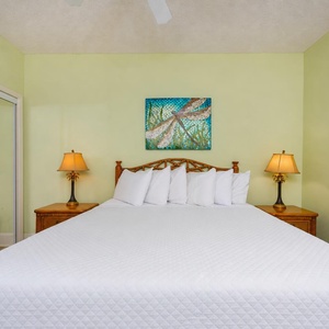 Drift into peaceful sleep surrounded by plush king bedding, inviting decor, and cheerful colors enhancing your retreat