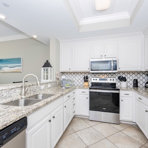 Craft delicious coastal-inspired meals while enjoying the inviting ambiance of this beautiful kitchen