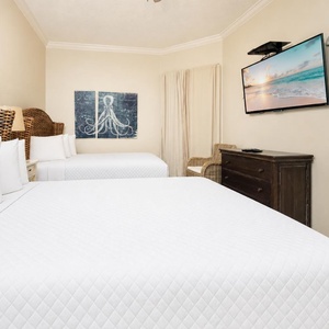 Savor restful nights on two queen beds while enjoying your favorite shows in this welcoming guest room