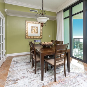 Gather around this inviting dining table, taking in delightful coastal vistas through expansive glass doors