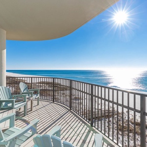 Relax on the spacious balcony with Adirondack chairs, enjoying panoramic views of the tranquil waters and beach