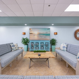 Relax in this inviting lounge with beach views, comfortable seating, and a cozy atmosphere perfect for unwinding