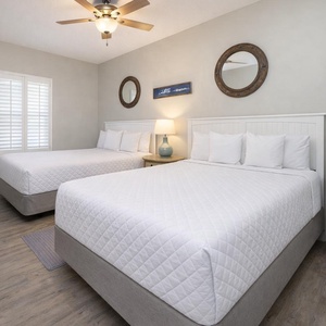 Unwind in this queen guest suite, where plush bedding and nautical decor create a restful retreat for your family