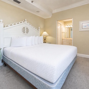 Unwind in this guest bedroom featuring a plush king bed, tasteful decor, and a TV for your entertainment