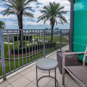 Savor coastal breezes while unwinding on the balcony, taking in tranquil views and lush palm surroundings