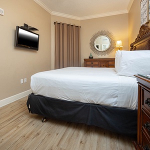 Relax on the cozy king bed in this guest suite and find something on the TV after a beach day