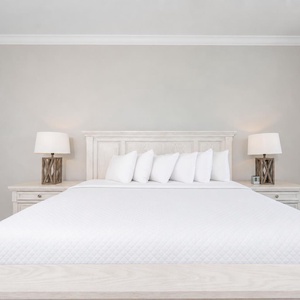 Serene master bedroom featuring a plush king bed, stylish lamps, and soft curtains that invite relaxation