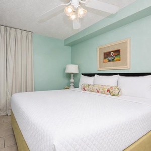 Relax in the spacious bedroom featuring a king bed, soft linens, and a flat-screen TV for your entertainment