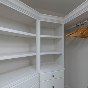 Store your belongings easily in this spacious closet with shelves and hanging space for your convenience