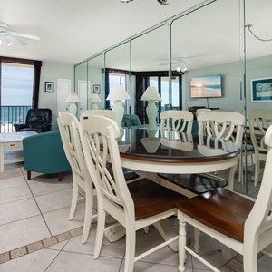 Gather around the dining table, enjoying beachfront views through from the balcony