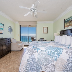 Experience restful nights in this inviting mastervbedroom with a king bed, coastal decor, and beachfront balcony access